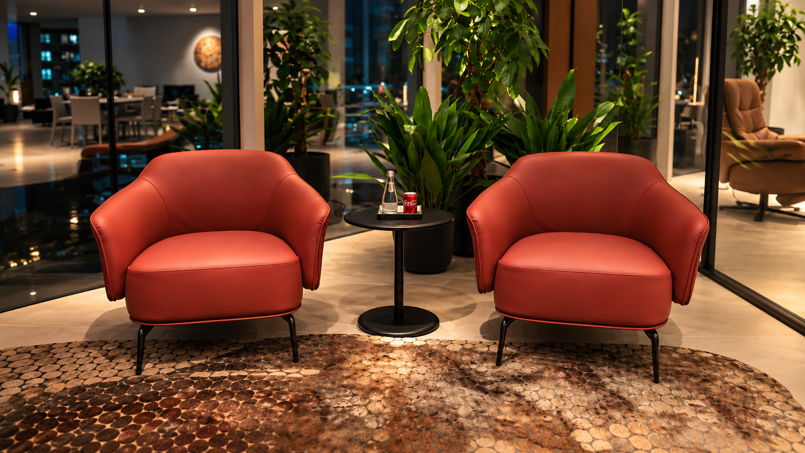 Hotel lobby lounge with two red armchairs and a patterned rug