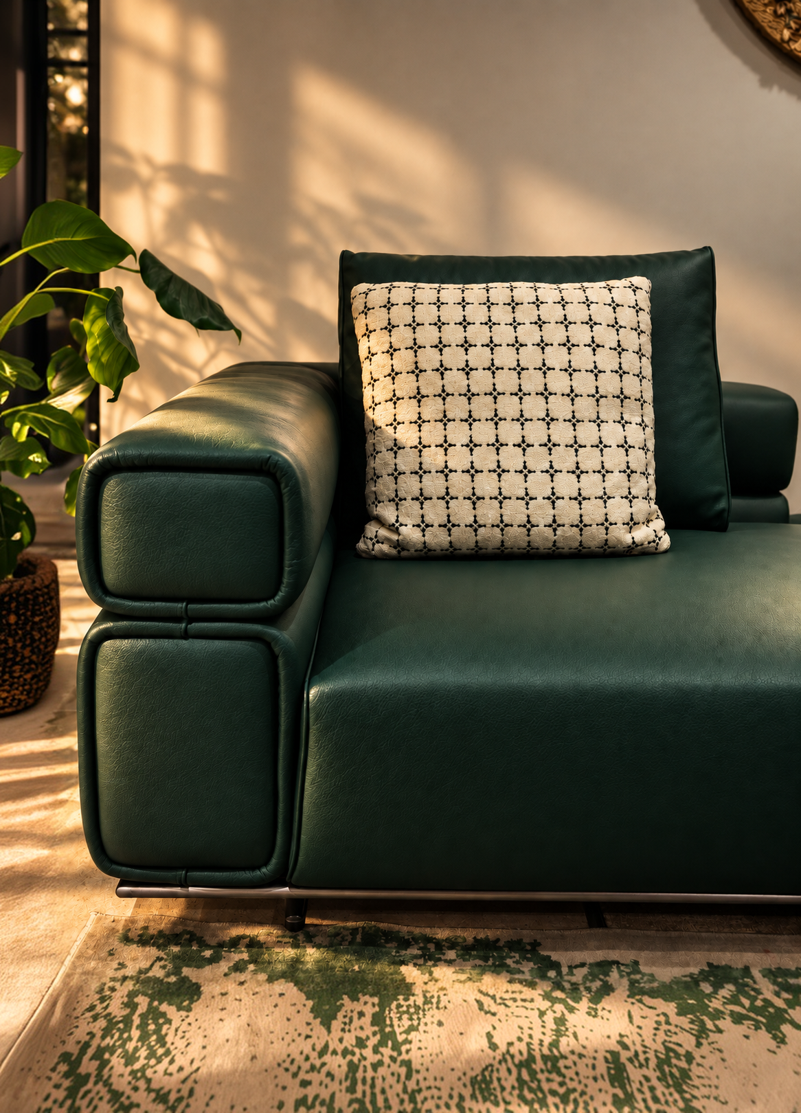 Dark green leather sofa with a patterned cushion